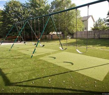 swing set on artificial grass lawn